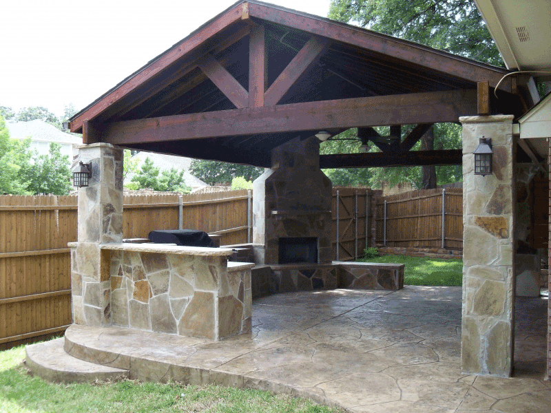 Exposed-beam-patio-cover-with-outdoor-kitchen-and-Outdoor-Fire-place-in-The-woodlands-Texas.-JM-Outdoor-Living