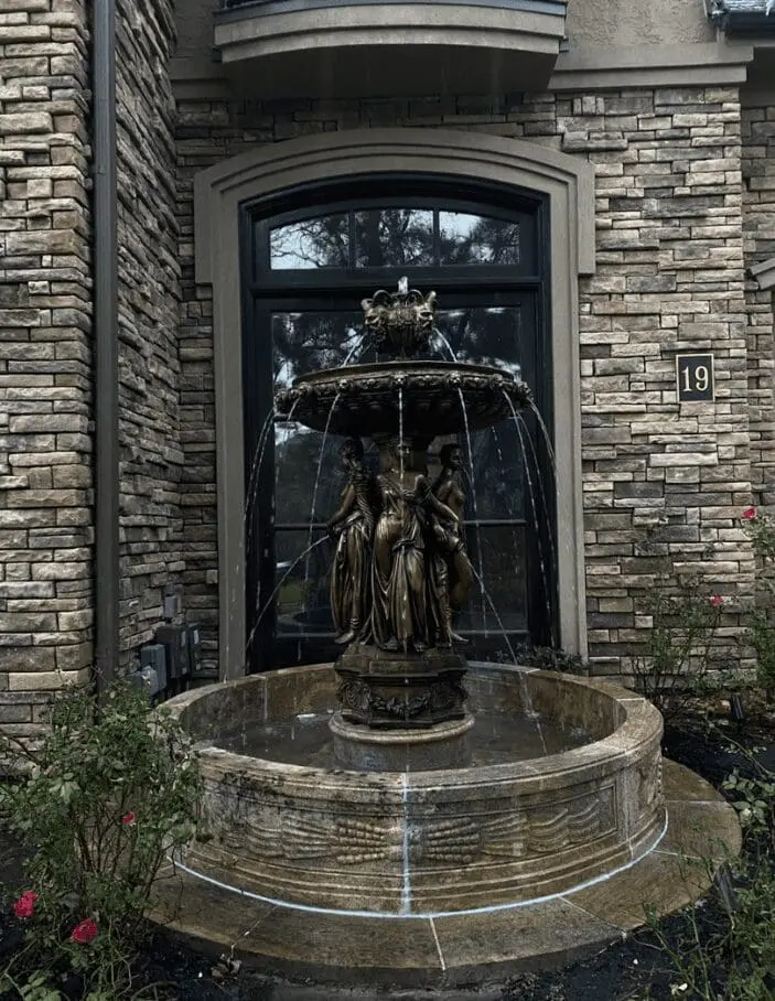Decorative bronze water fountain at custom home in The Woodlands, Texas.