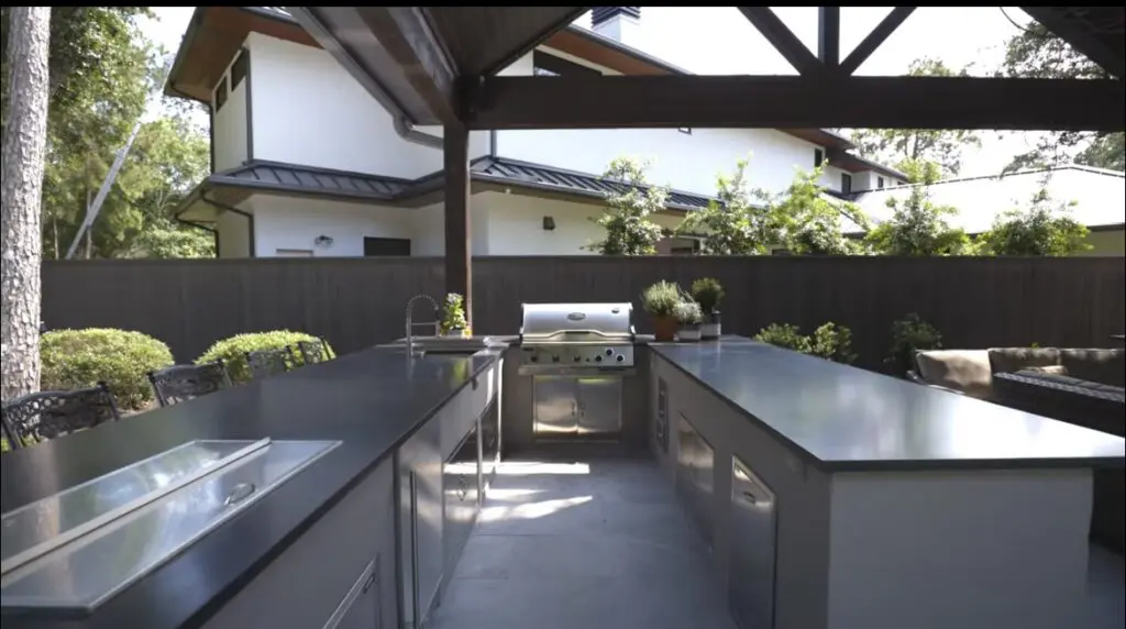Luxury outdoor kitchen with stainless steel appliances and stone countertops by JM Outdoor Living in The Woodlands, Texas.