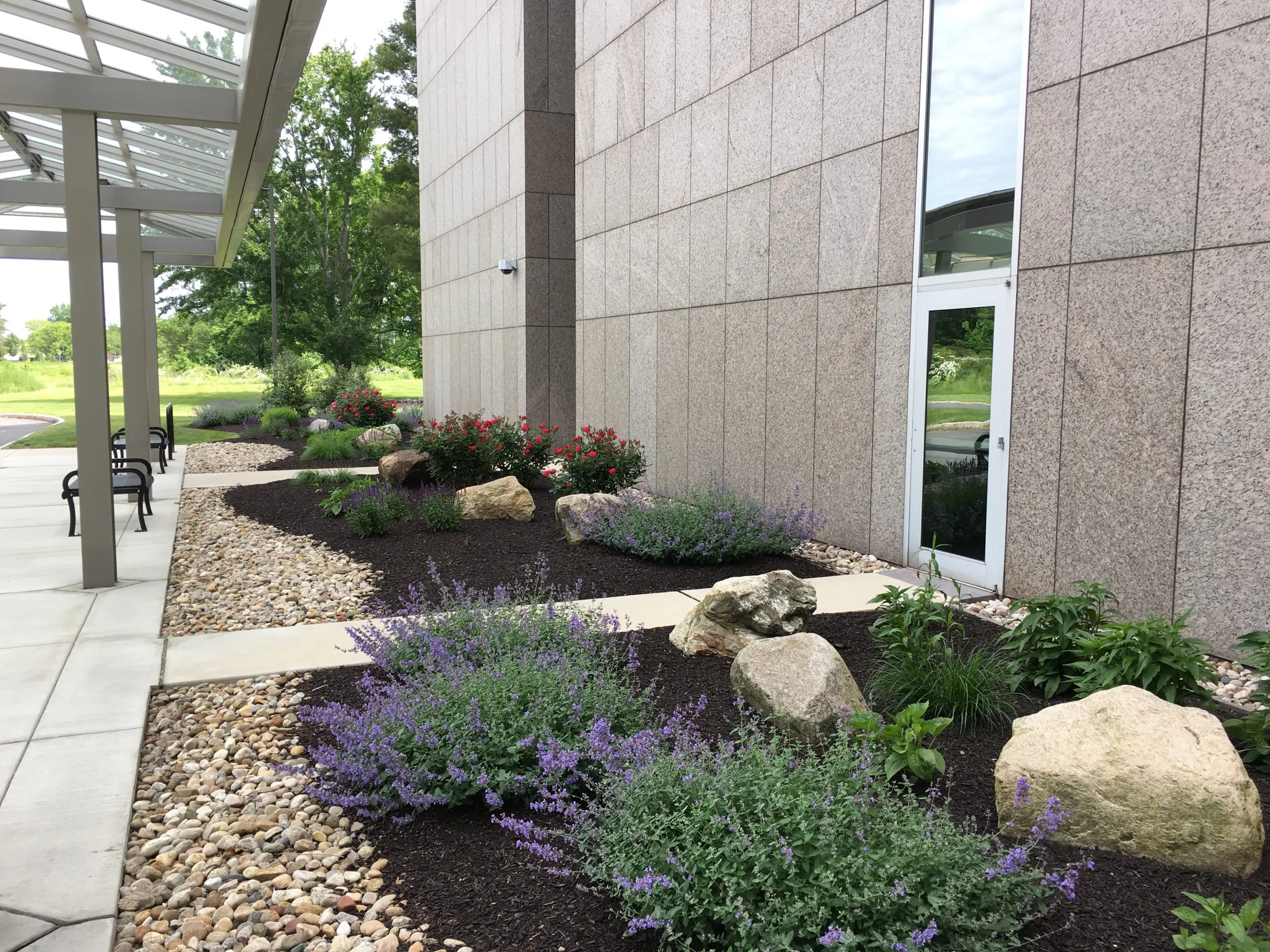 Finished office building landscape with stone beds and shrubs